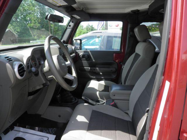 2010 Red Jeep Wrangler Unlimited Sahara 4WD (1J4BA5H13AL) with an 3.8L V6 engine, MAN transmission, located at 19521 New George's Creek Rd SW, Barton, MD, 21521, (301) 463-2404, 39.524323, -79.017906 - Photo#1