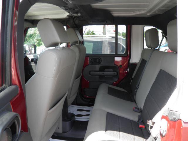 2010 Red Jeep Wrangler Unlimited Sahara 4WD (1J4BA5H13AL) with an 3.8L V6 engine, MAN transmission, located at 19521 New George's Creek Rd SW, Barton, MD, 21521, (301) 463-2404, 39.524323, -79.017906 - Photo#3